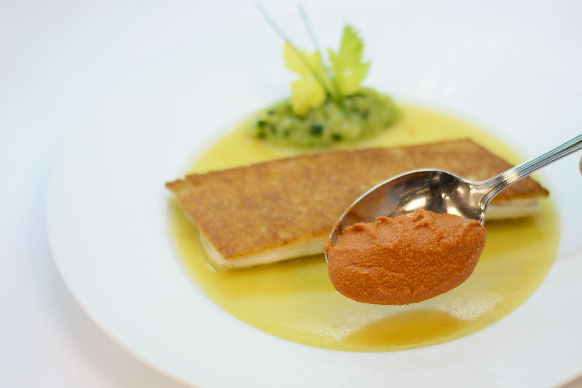 Spanish branzino with saffron fumet and romesco