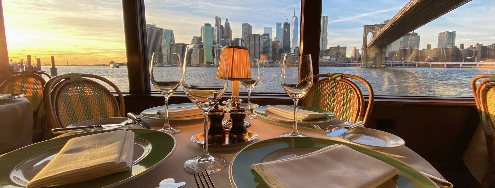 Table set for dinner overlooking the Manhattan skyline and Brooklyn Bridge